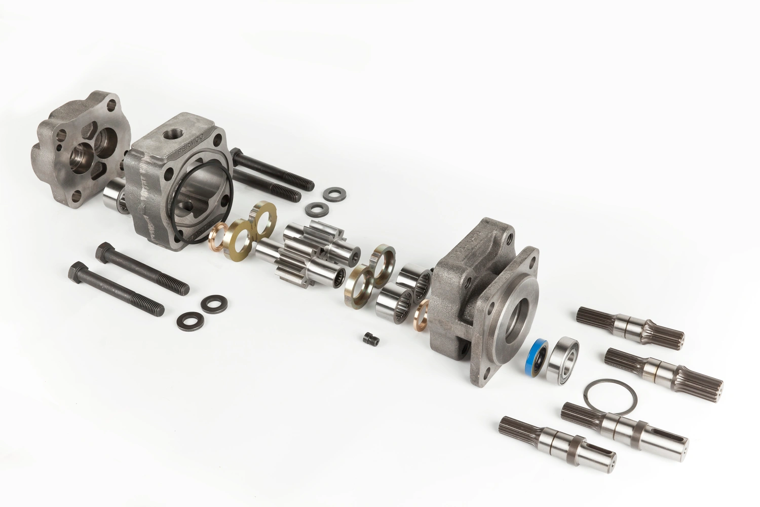 An exploded view of engine components, including two cast cylinder heads, gears, bolts, and various metallic parts on a white background.