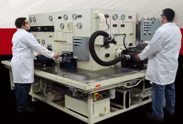 Three hydraulic pumps with metallic finishes and yellow accents, displayed on a white background, showcasing their design and components.